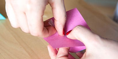 cut a piece of fishing line and tape it to the non-sticky triangle