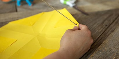 Let your kids build the parachute, reminding them that they want it to fall as slowly as possible